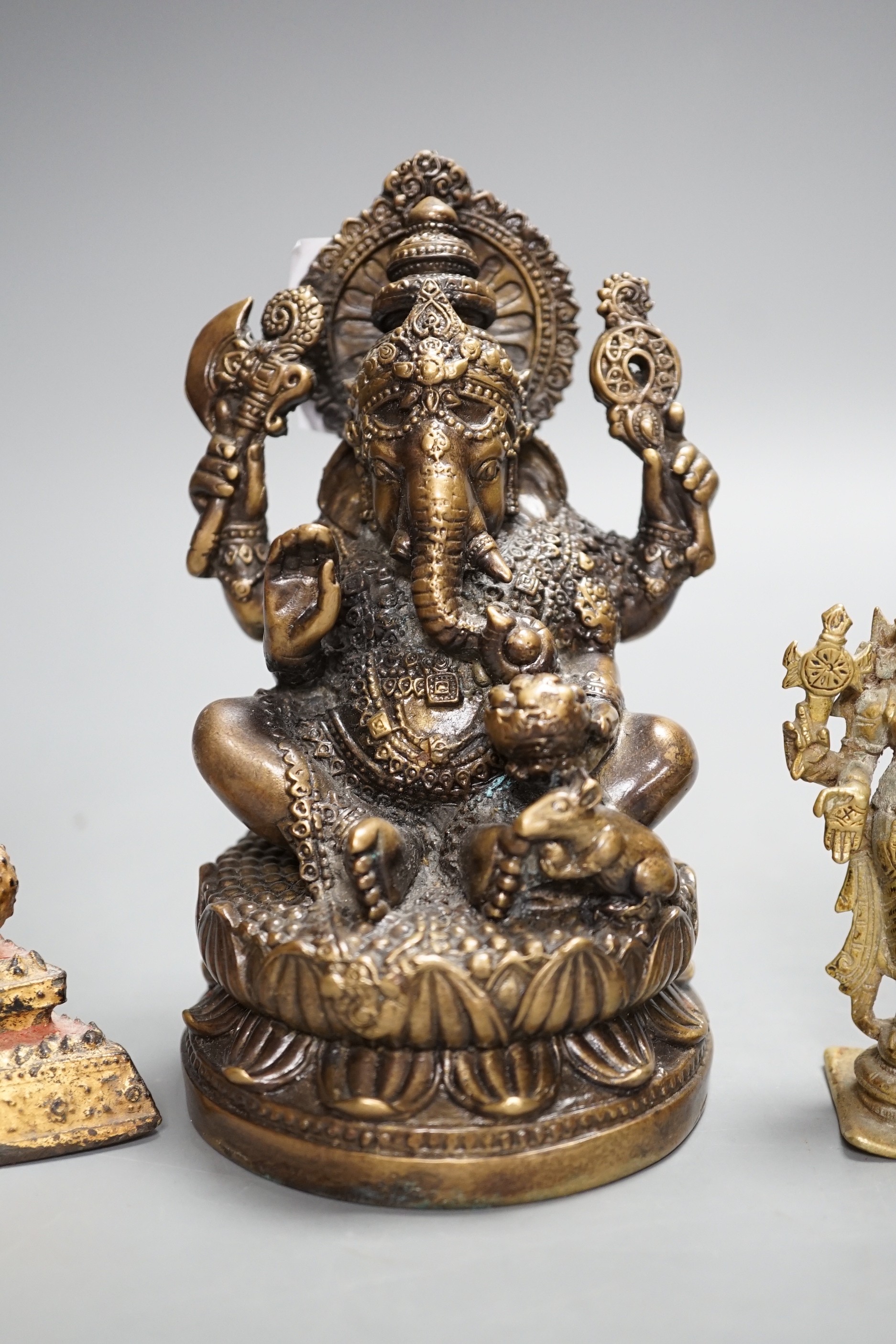 A Thai gilt resin model of Buddha, an Indian bronze model of Ganesh, a jadeite coloured carving of Guanyin and two other figures. Tallest 30cm